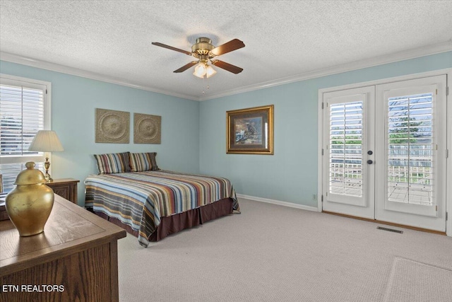 bedroom with access to outside, multiple windows, visible vents, and carpet floors