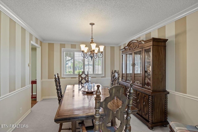 carpeted dining area featuring a textured ceiling, wallpapered walls, an inviting chandelier, and ornamental molding