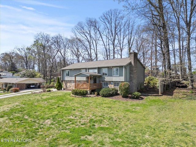 view of front of house with a carport, a chimney, concrete driveway, and a front lawn