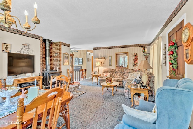 living room with a wood stove, a textured ceiling, and carpet floors