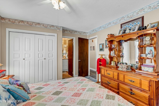 carpeted bedroom with a closet, baseboards, a ceiling fan, and a textured ceiling