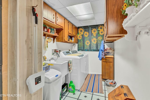 washroom featuring tile patterned floors, cabinet space, and washing machine and dryer