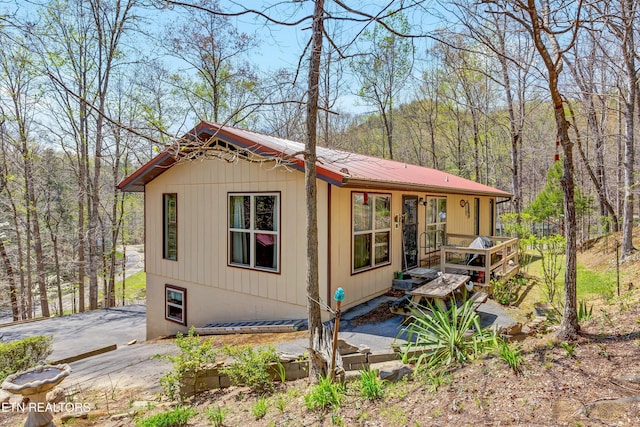 exterior space featuring a forest view