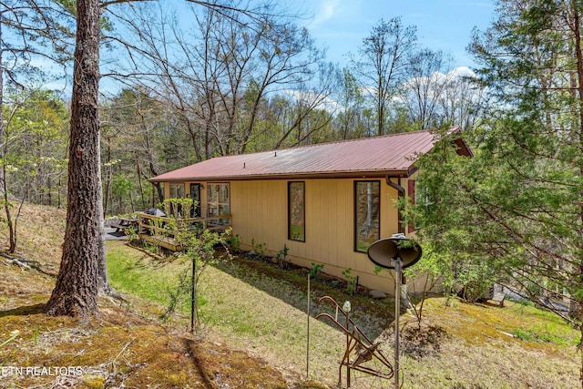 view of property exterior with metal roof