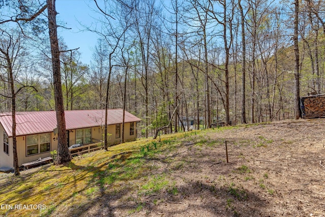 view of yard with a forest view