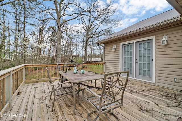 deck with french doors and outdoor dining space