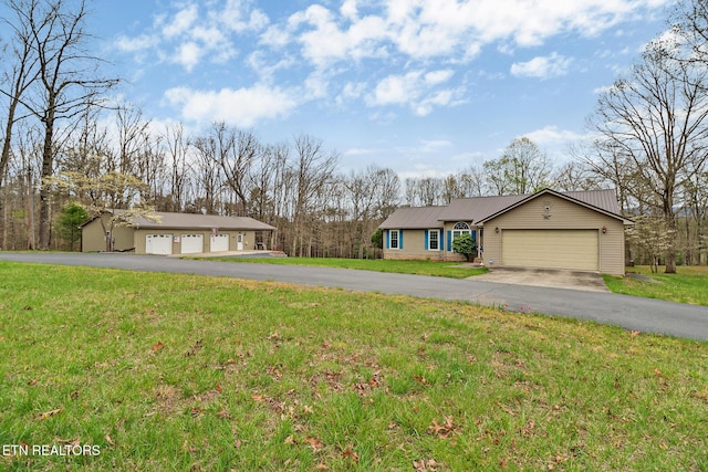 single story home with metal roof, driveway, and a front lawn