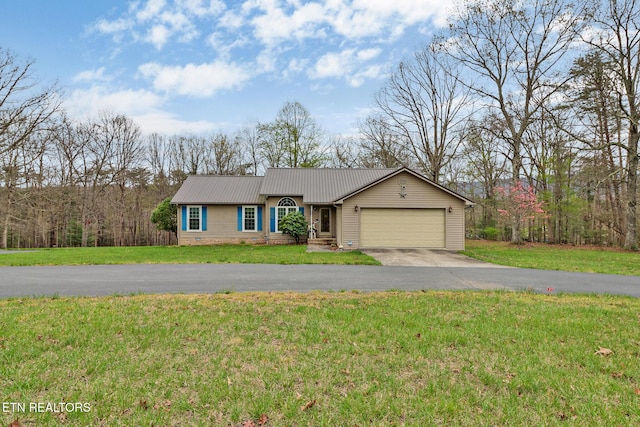 single story home featuring driveway, a front lawn, metal roof, and a garage