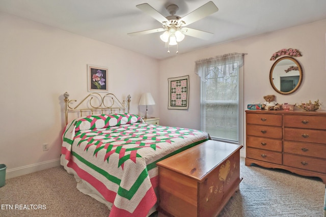 bedroom with carpet, baseboards, and a ceiling fan