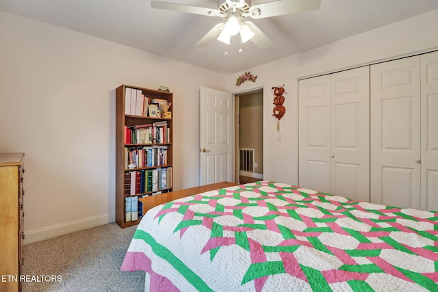 carpeted bedroom featuring a closet, ceiling fan, visible vents, and baseboards