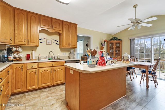 kitchen with light countertops, a sink, a ceiling fan, and a wealth of natural light