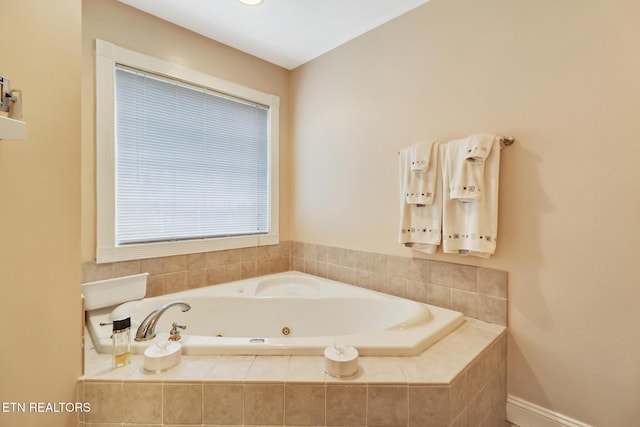 bathroom with a tub with jets