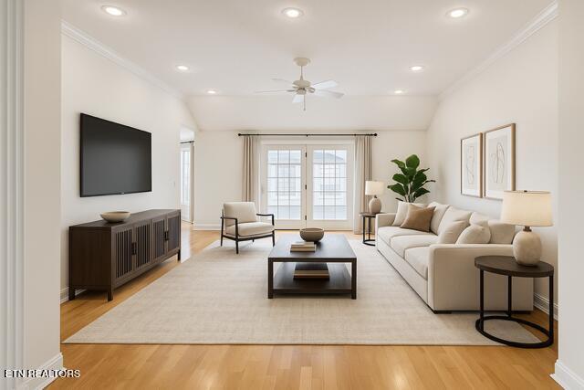 living room featuring crown molding, baseboards, and ceiling fan