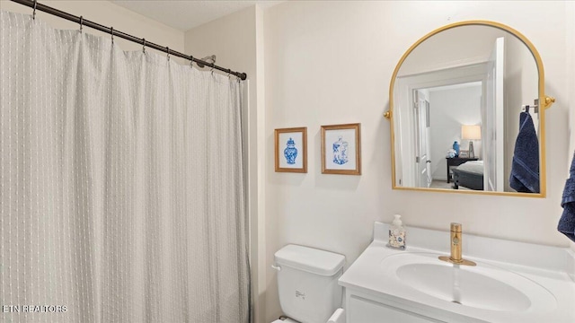 ensuite bathroom with vanity, ensuite bathroom, and toilet