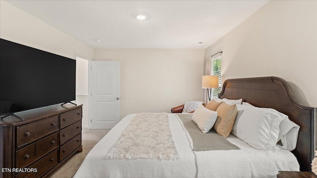 bedroom featuring light carpet