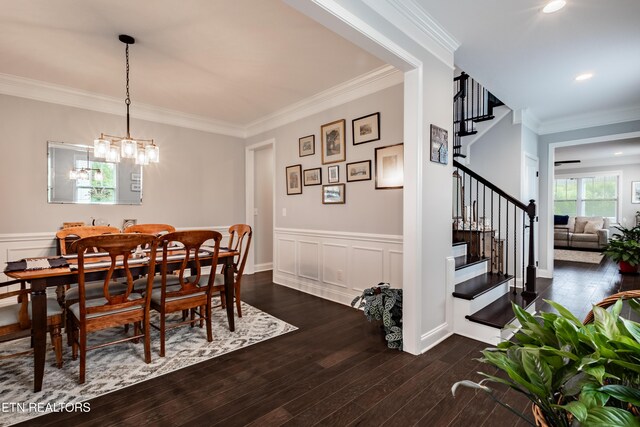 dining room with dark wood-style floors, stairs, a decorative wall, ornamental molding, and wainscoting