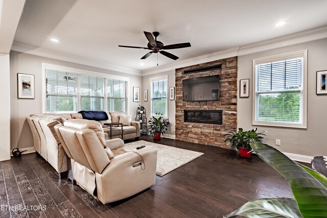 living room featuring ornamental molding, dark wood finished floors, a ceiling fan, and baseboards