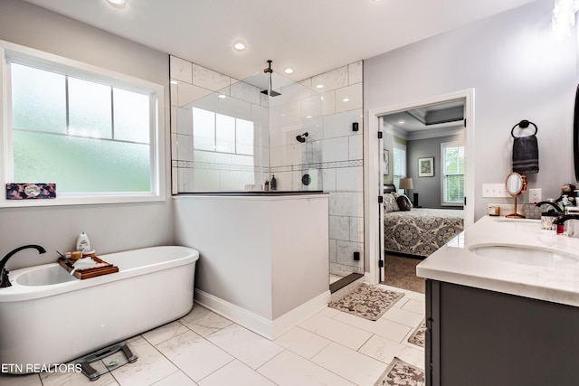 ensuite bathroom featuring recessed lighting, connected bathroom, a shower stall, vanity, and a soaking tub