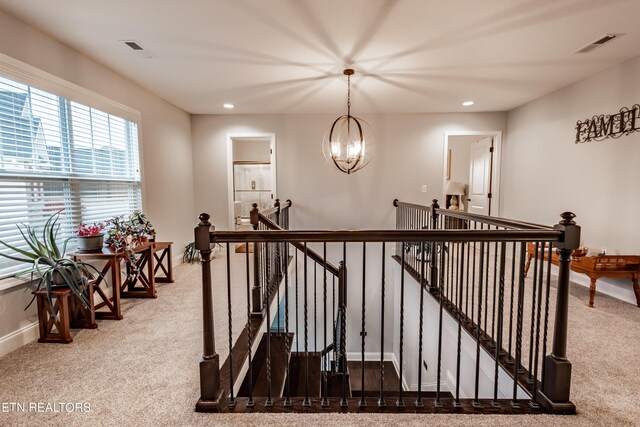 corridor with visible vents, an upstairs landing, carpet, and recessed lighting