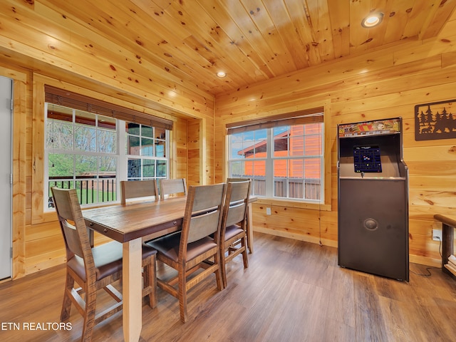 dining area featuring wooden ceiling, wooden walls, wood finished floors, and recessed lighting