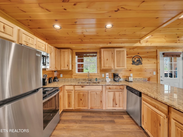 kitchen with stainless steel appliances and light brown cabinetry