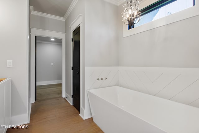 686 Ironwood Ln, Loudon, TN 37774 - bathroom featuring ornamental molding, a freestanding bath, a chandelier, wood finished floors, and baseboards