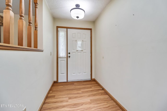 214 Snead Dr, Crossville, TN 38558 - entryway with a textured ceiling, light wood-style flooring, and baseboards