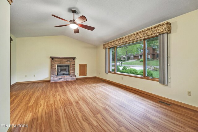 214 Snead Dr, Crossville, TN 38558 - unfurnished living room featuring wood finished floors, a ceiling fan, visible vents, baseboards, and vaulted ceiling