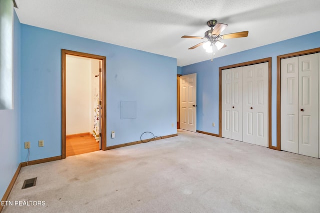 214 Snead Dr, Crossville, TN 38558 - unfurnished bedroom with two closets, baseboards, visible vents, and carpet