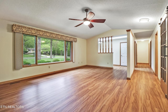 214 Snead Dr, Crossville, TN 38558 - interior space with light wood-style flooring, a ceiling fan, a textured ceiling, baseboards, and lofted ceiling