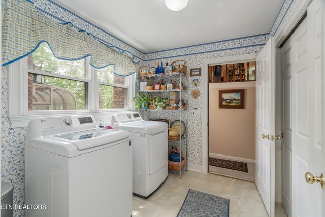 washroom featuring laundry area, independent washer and dryer, and wallpapered walls