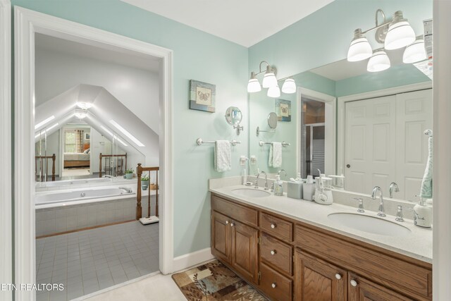 full bath with double vanity, a sink, a garden tub, and a stall shower