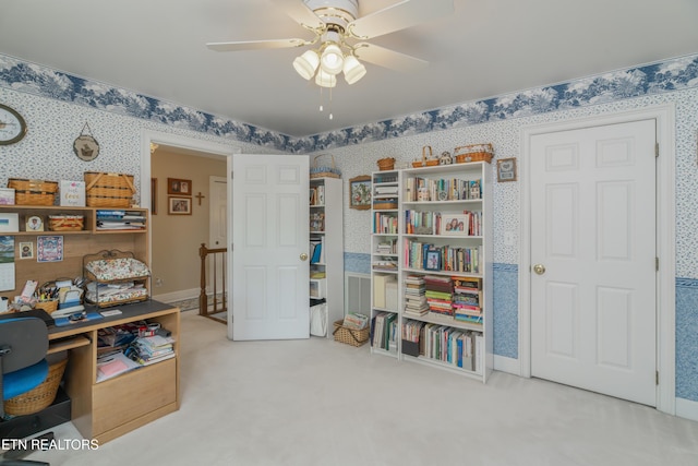 office area with carpet floors, a ceiling fan, and wallpapered walls