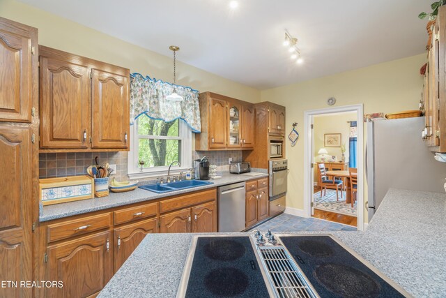 kitchen featuring light countertops, stainless steel appliances, and a sink