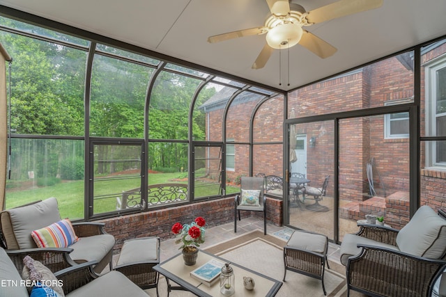 sunroom / solarium featuring ceiling fan and outdoor lounge area