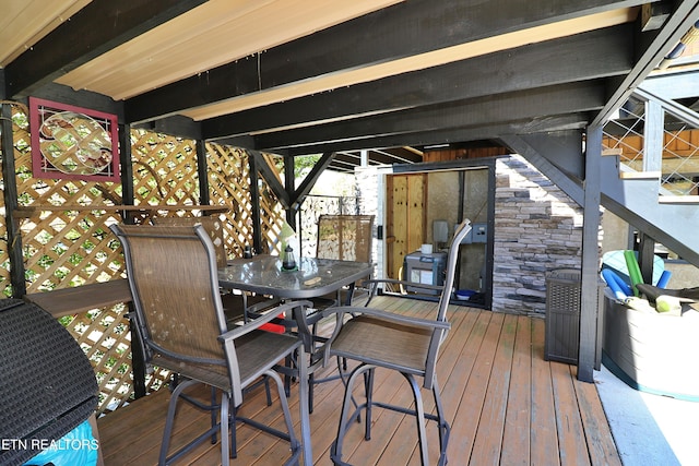 wooden deck featuring outdoor dining area