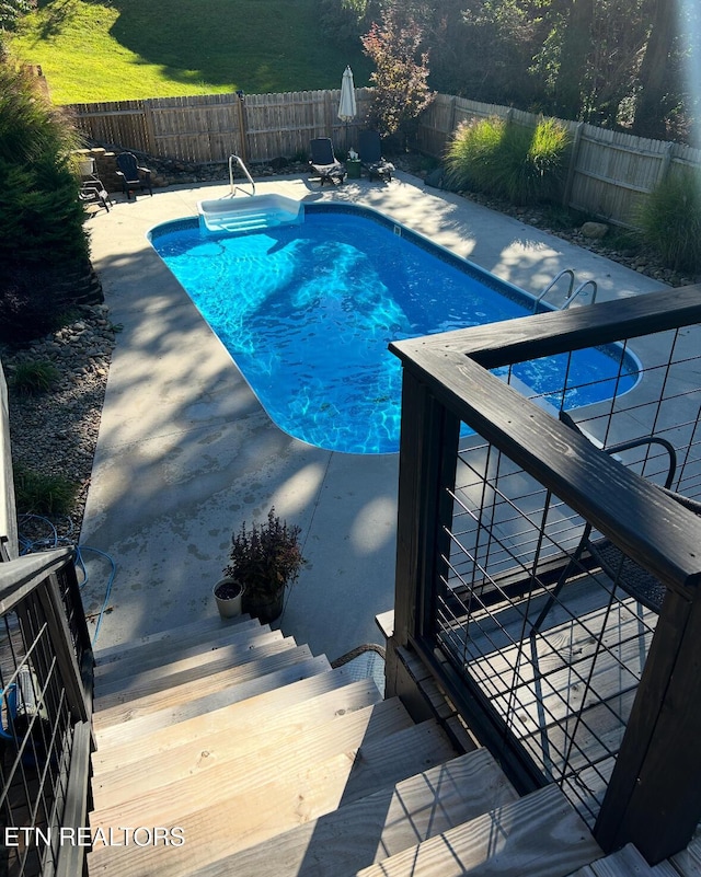 view of pool featuring a fenced backyard, a fenced in pool, and a patio