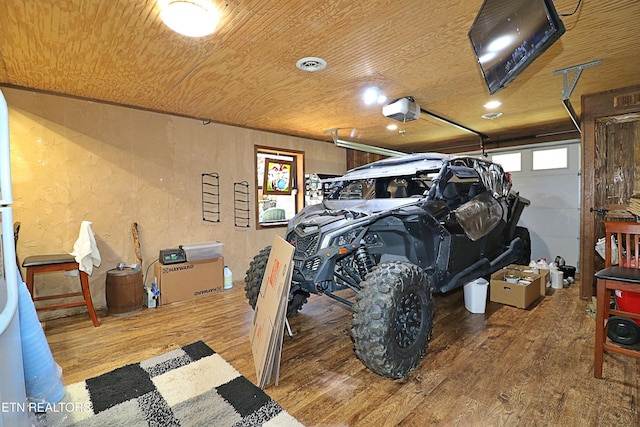 garage with visible vents, a textured wall, a garage door opener, and wood ceiling