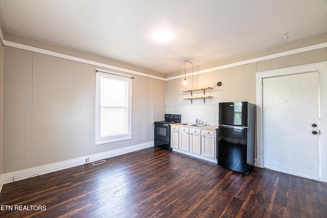 kitchen featuring a sink, baseboards, black appliances, and dark wood-style flooring