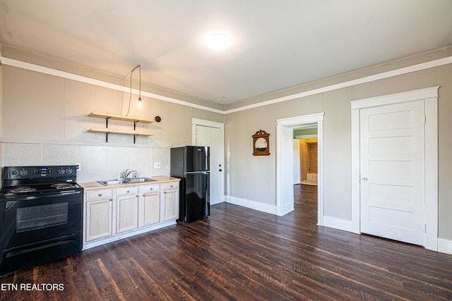 kitchen featuring a sink, dark wood-style flooring, light countertops, black appliances, and backsplash