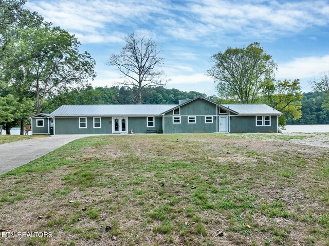 4225 W Lakeview Cir, Louisville, TN 37777 - view of front of home featuring metal roof, driveway, a front lawn, and french doors