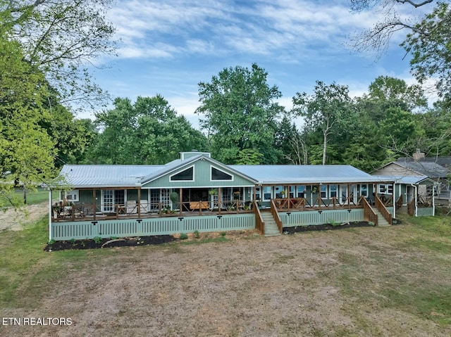 4225 W Lakeview Cir, Louisville, TN 37777 - rear view of property with a deck, metal roof, and view of wooded area