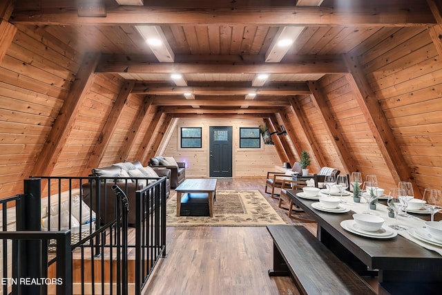 interior space featuring wood walls, hardwood / wood-style flooring, wood ceiling, and vaulted ceiling with beams