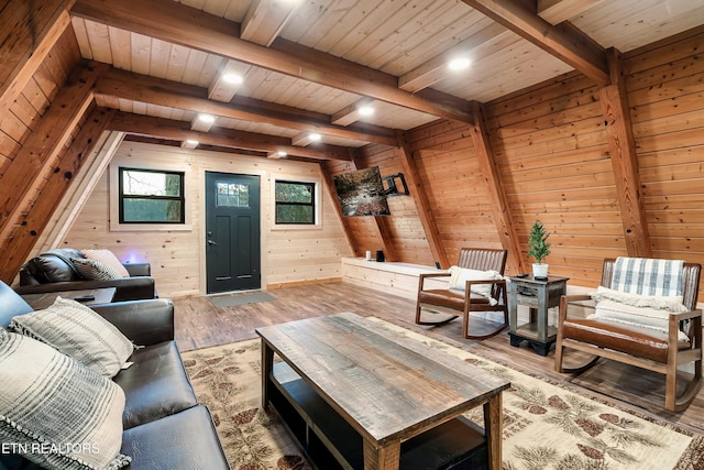 living area featuring wood walls, wooden ceiling, hardwood / wood-style flooring, and beamed ceiling