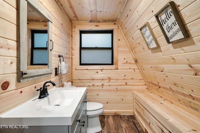 bathroom featuring vanity, toilet, wood ceiling, wood finished floors, and wooden walls