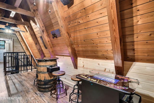 interior space featuring a sauna, wood walls, vaulted ceiling with beams, and wood finished floors