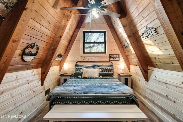 bedroom with wood finished floors and wood walls