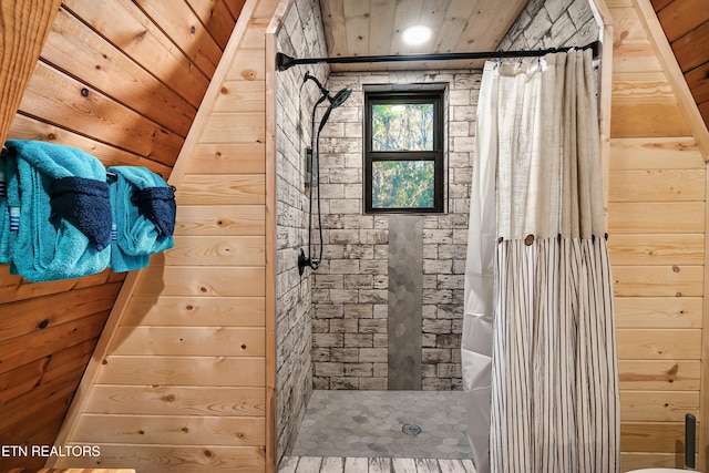 bathroom with wood walls and a tile shower
