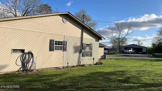 798 Lawson Rd, Crossville, TN 38571 - view of side of property featuring an outdoor structure, a lawn, and a detached garage