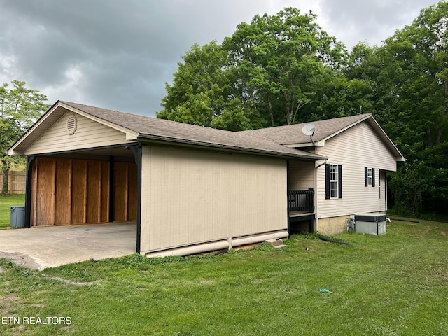 798 Lawson Rd, Crossville, TN 38571 - view of home's exterior with a carport, a lawn, and a shingled roof